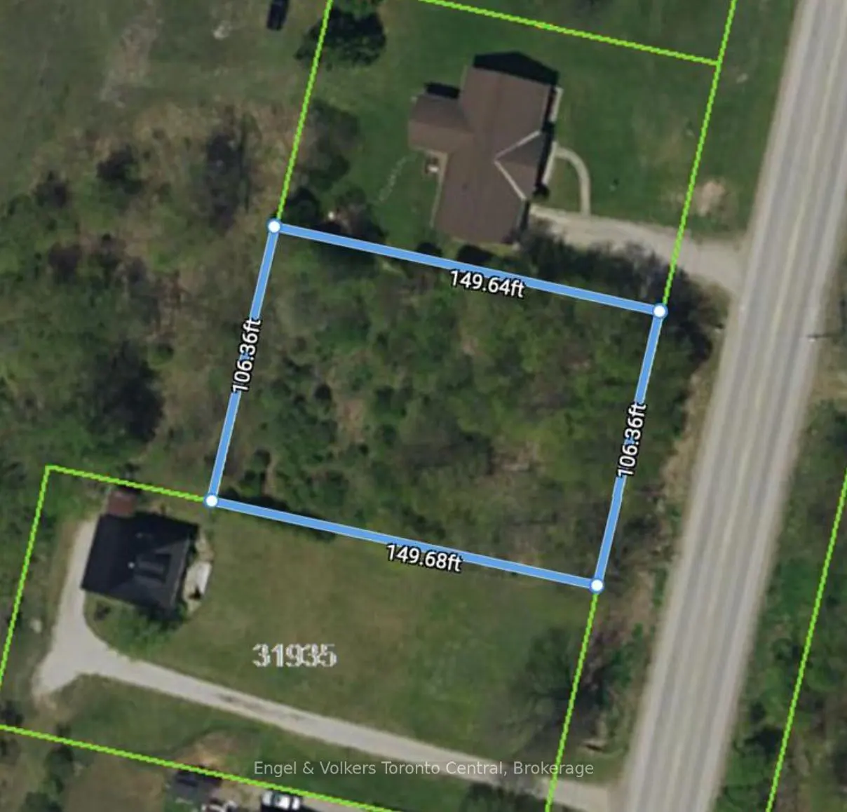 Aerial view of a vacant lot outlined in blue, showing dimensions, with a house and road nearby.