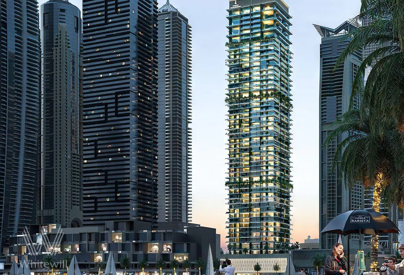 Exterior shot of a tall, modern, blue glass condo building with balconies and greenery, surrounded by other skyscrapers.