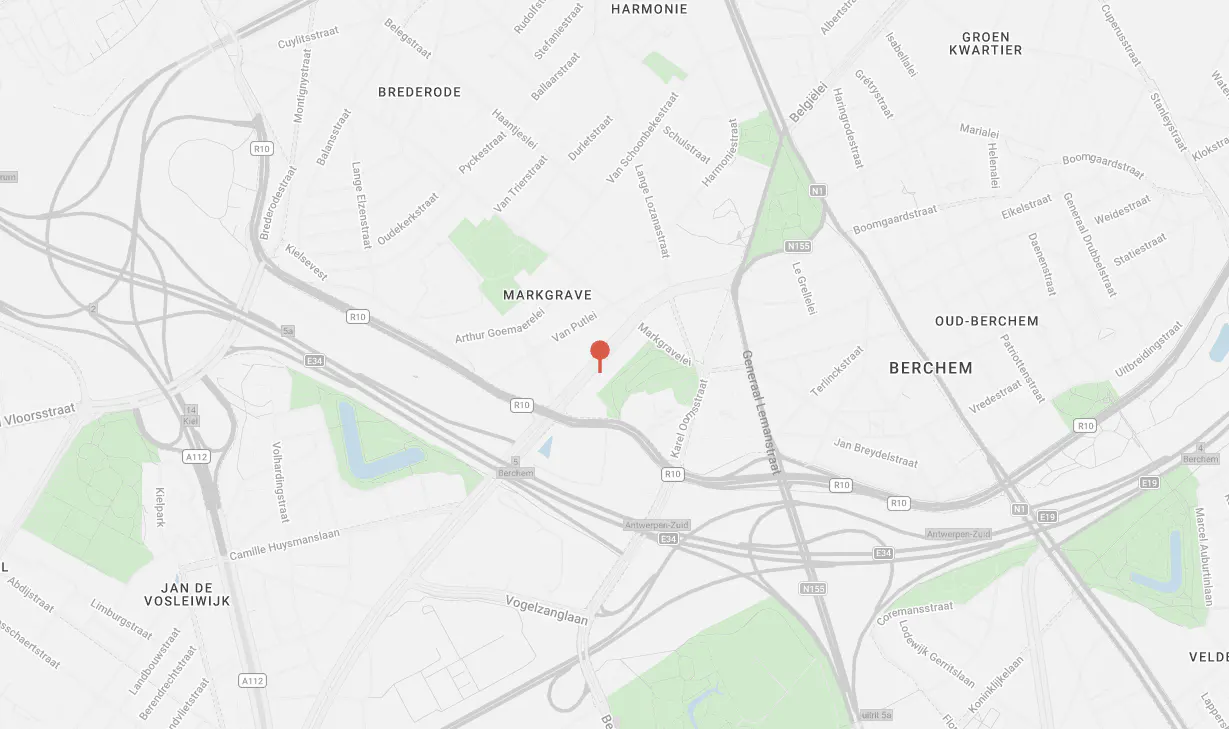 Map view of Markgrave, Belgium, with streets, parks, and a red pin marking a location. Roads are gray, parks are green, and text labels areas.