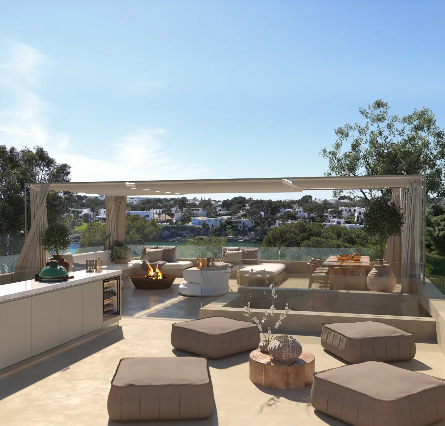 Luxury rooftop patio with lounge seating, fire pit, and outdoor kitchen overlooking a coastal view under a clear blue sky.