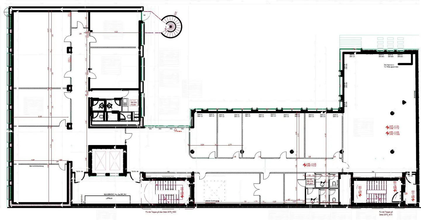 Blueprint of a commercial building, showing the layout of offices, bathrooms, stairwells, and a circular staircase.