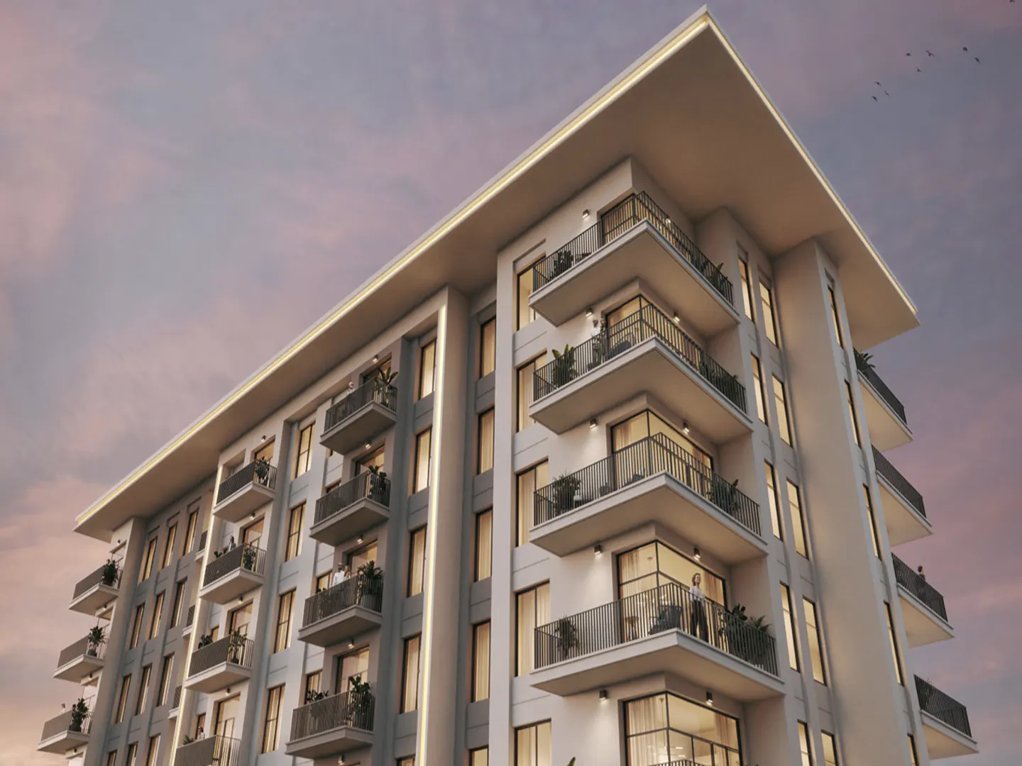 Modern white apartment building with balconies, under a pink and purple sky.