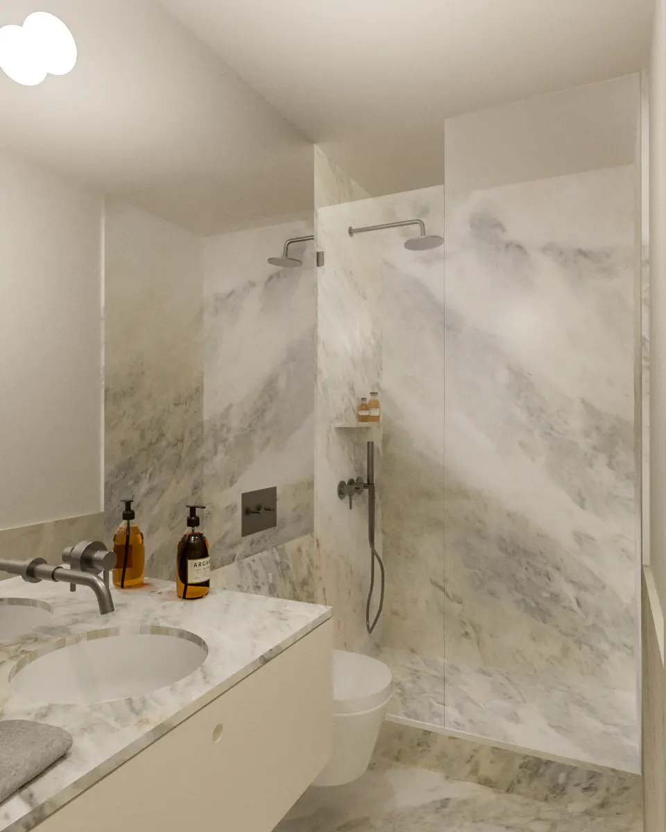 Modern bathroom with marble walls, a white vanity with two sinks, and a glass-enclosed shower with dual shower heads.