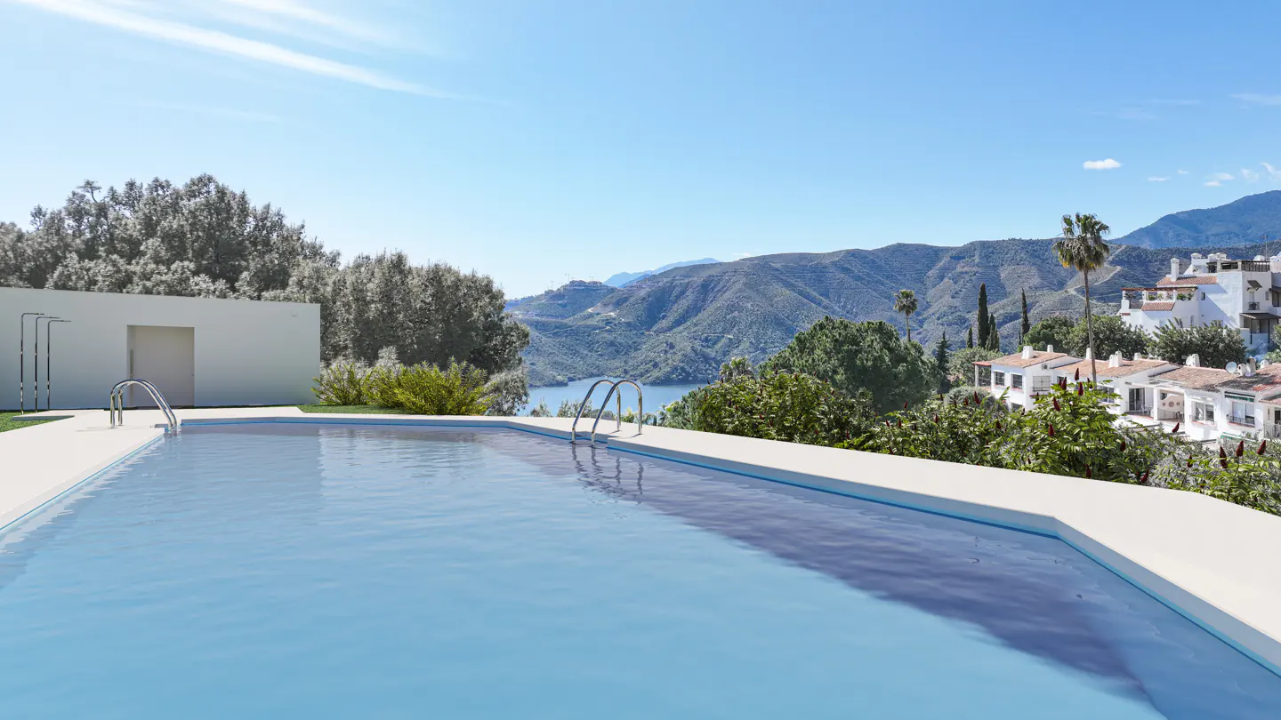 A bright blue swimming pool with a mountain view. White buildings and green trees are in the background.