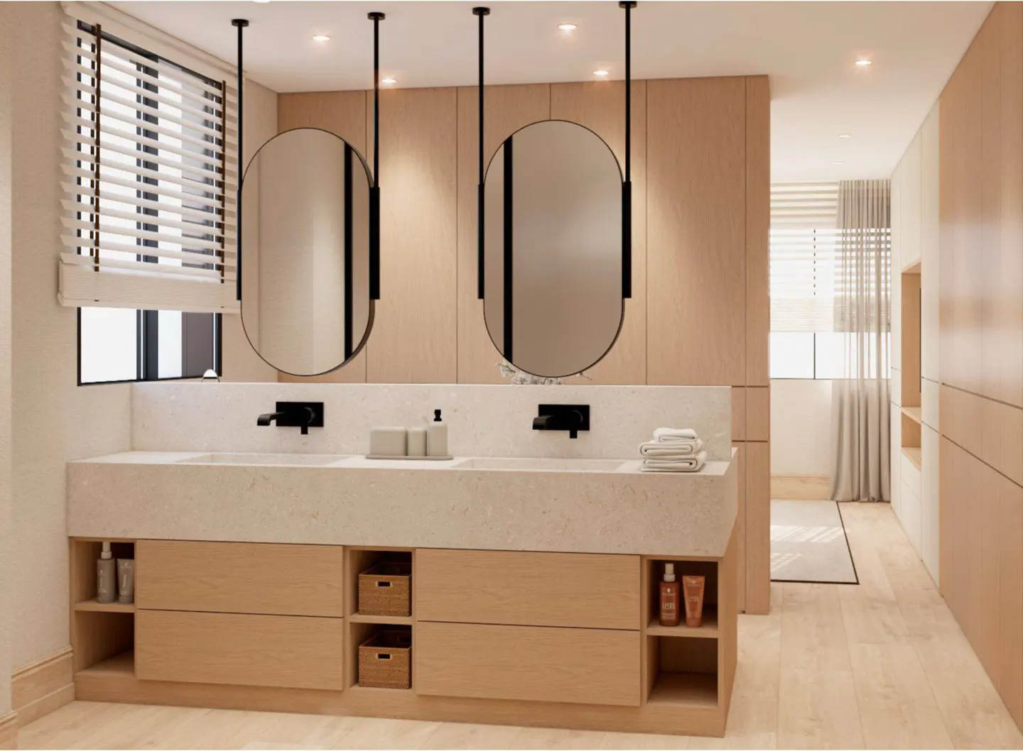 Bathroom with double sink vanity, light wood cabinets, black faucets, and oval mirrors hanging from the ceiling.