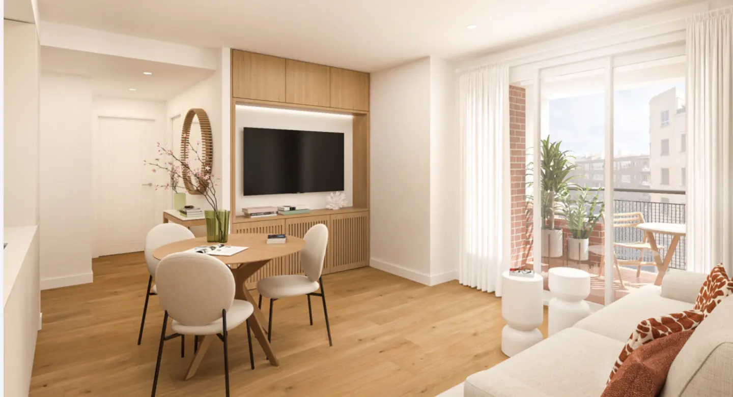 Bright apartment interior with wood floors, a round table with four chairs, a white sofa, and a balcony with plants.