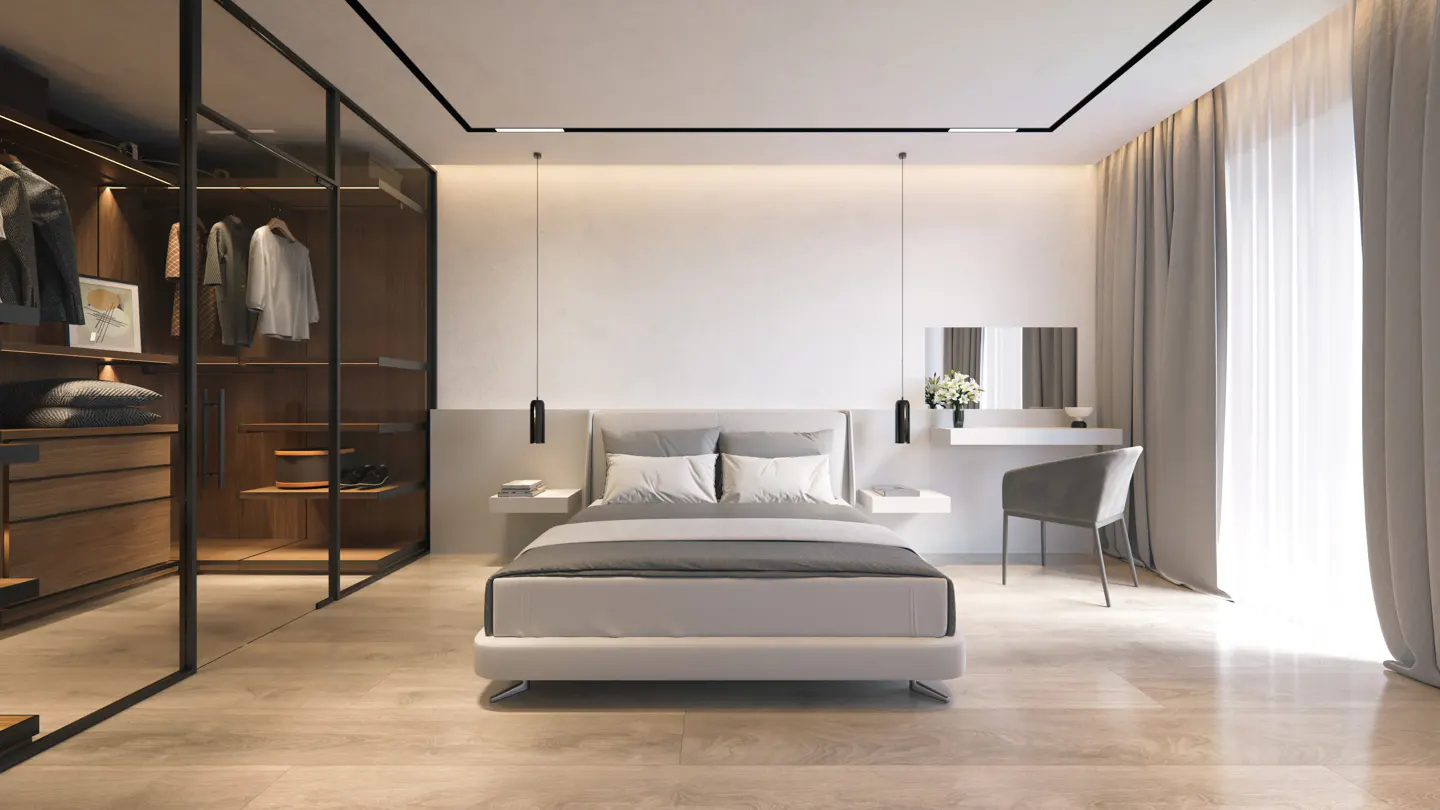 Modern bedroom with a gray bed, white walls, and a glass-enclosed closet. A vanity with a gray chair sits near sheer curtains.