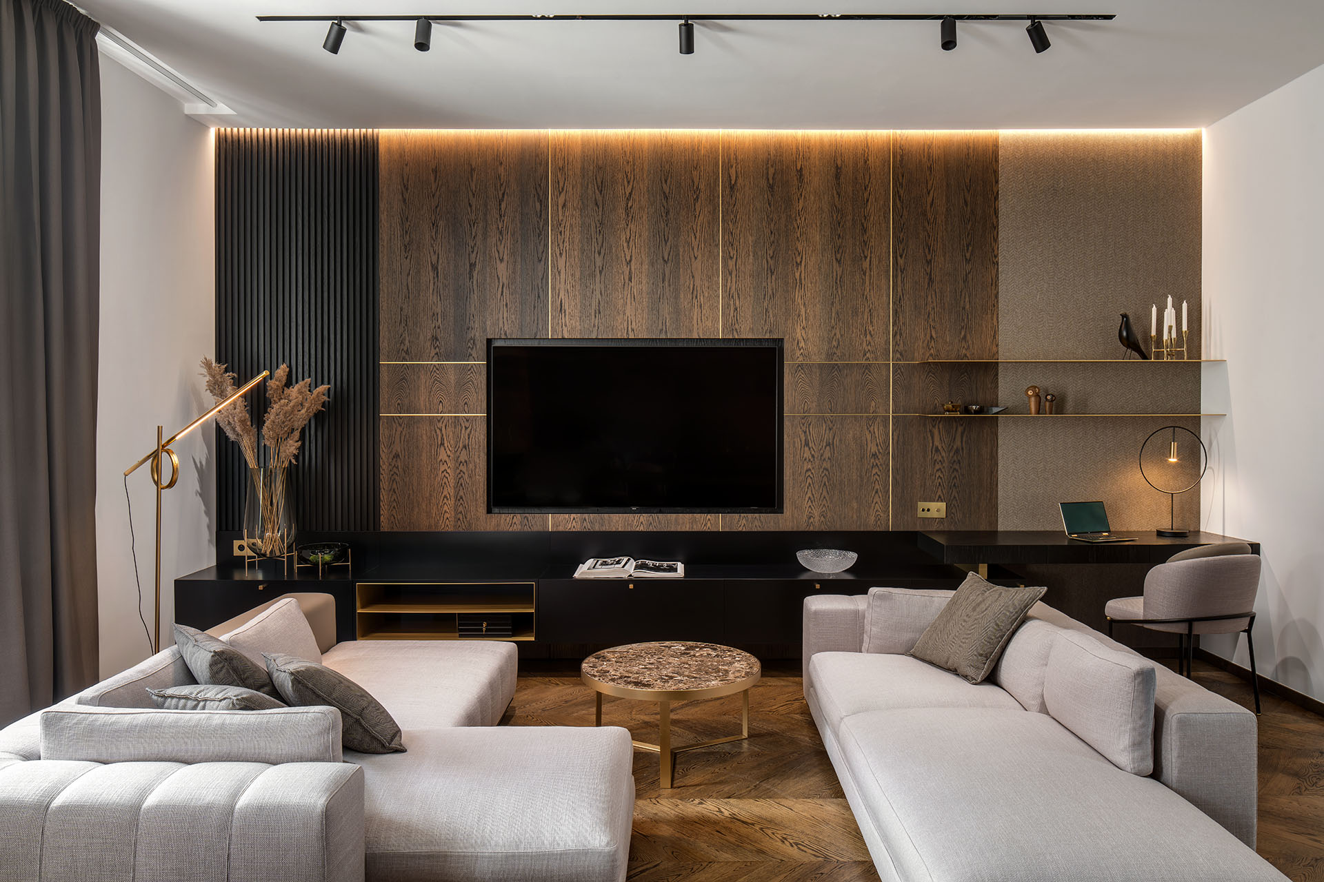 Modern living room with two light gray sofas, a marble coffee table, and a dark wood media wall with a mounted TV. [AI-generated text]