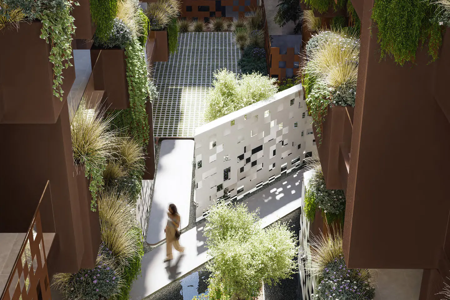 A woman walks on a white path in a courtyard with brown planters and greenery. A white wall with square cutouts is on the right.