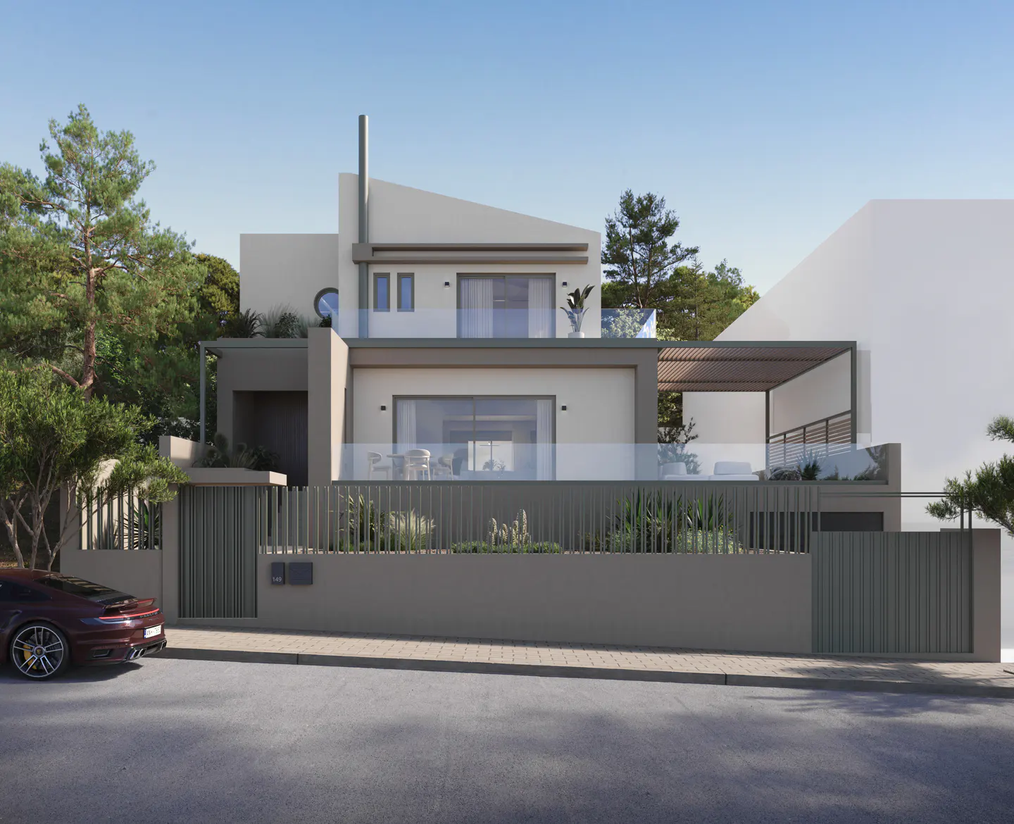 Two-story modern house with a gray fence, a red car parked on the street, and trees in the background.