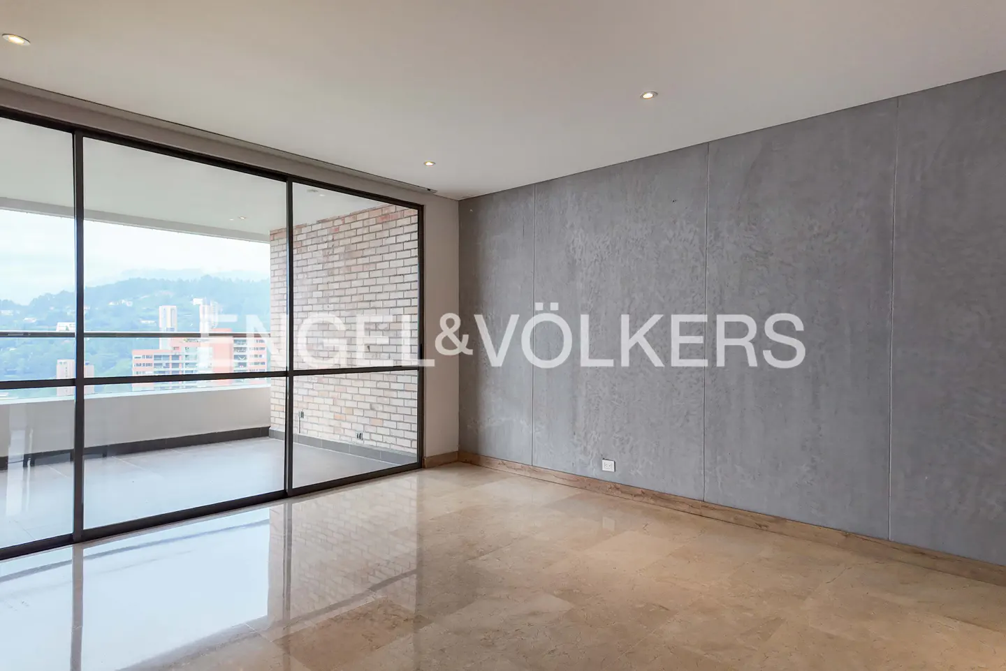 Empty room with marble floors, gray walls, and a large window with a view of the city.