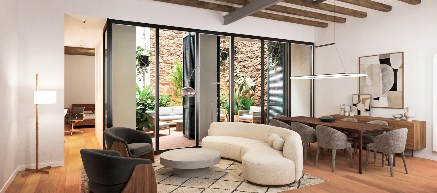 Bright living room with a curved white sofa, gray chairs, and a dining table. A courtyard is visible through glass doors.