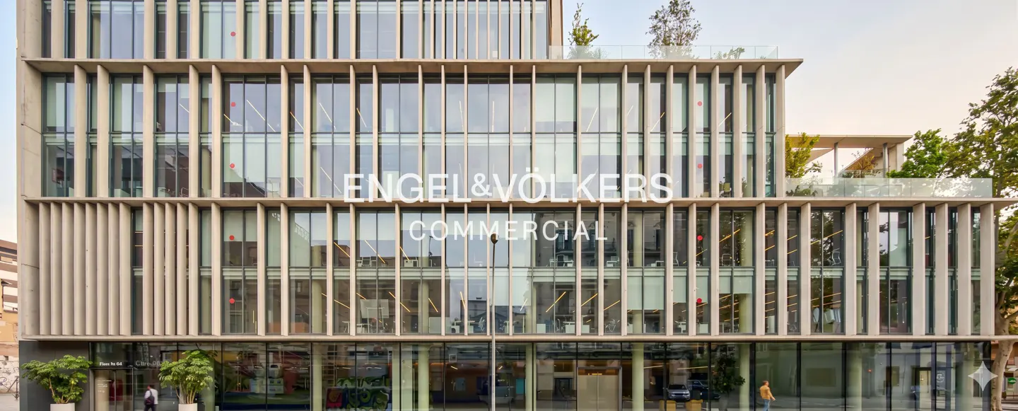 Exterior of Engel & Völkers Commercial building. Modern architecture with glass windows and vertical concrete slats.