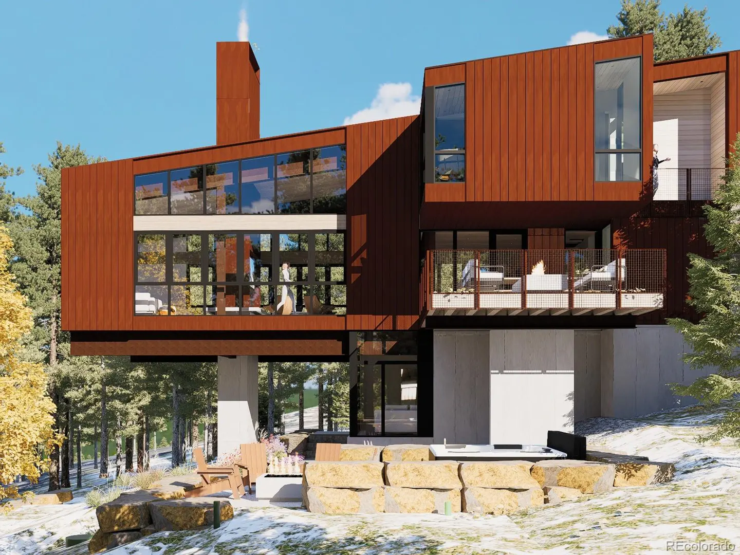 Modern brown house with large windows and a balcony, set in a snowy, wooded landscape. Outdoor seating and a hot tub are visible.