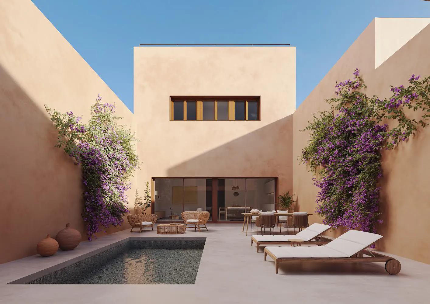 Courtyard view of a peach-colored house with a pool, lounge chairs, and purple bougainvillea on the walls.