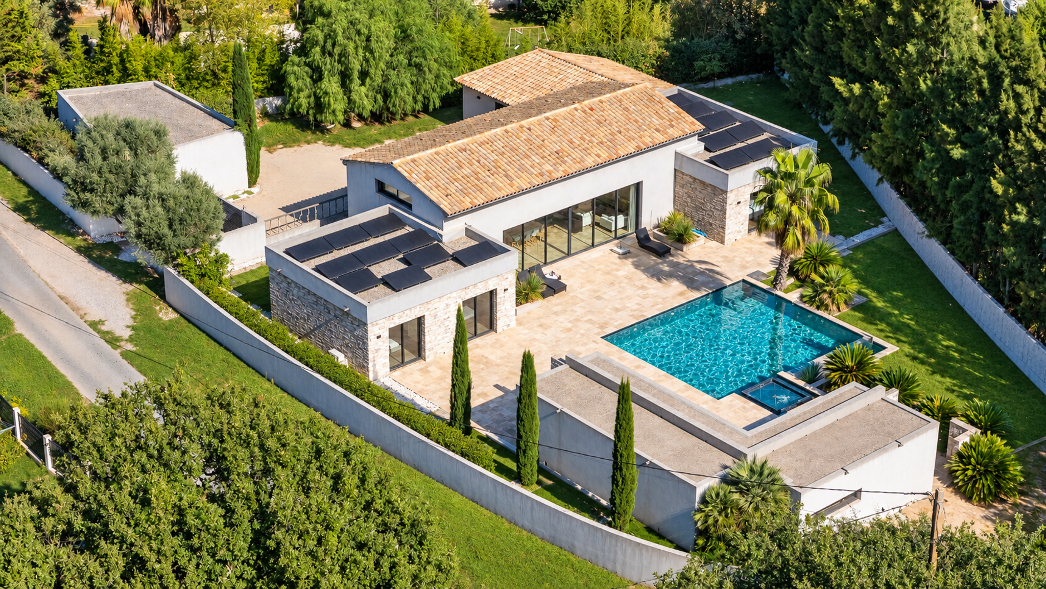 Aerial view of a modern villa with a terracotta roof, solar panels, stone accents, a swimming pool, and lush garden. [AI-generated text]