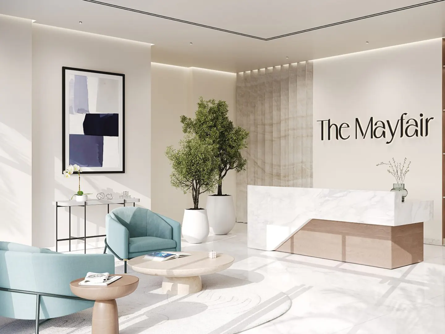 Bright lobby with light blue chairs, marble tables, and a reception desk with "The Mayfair" logo. Two potted trees add greenery.