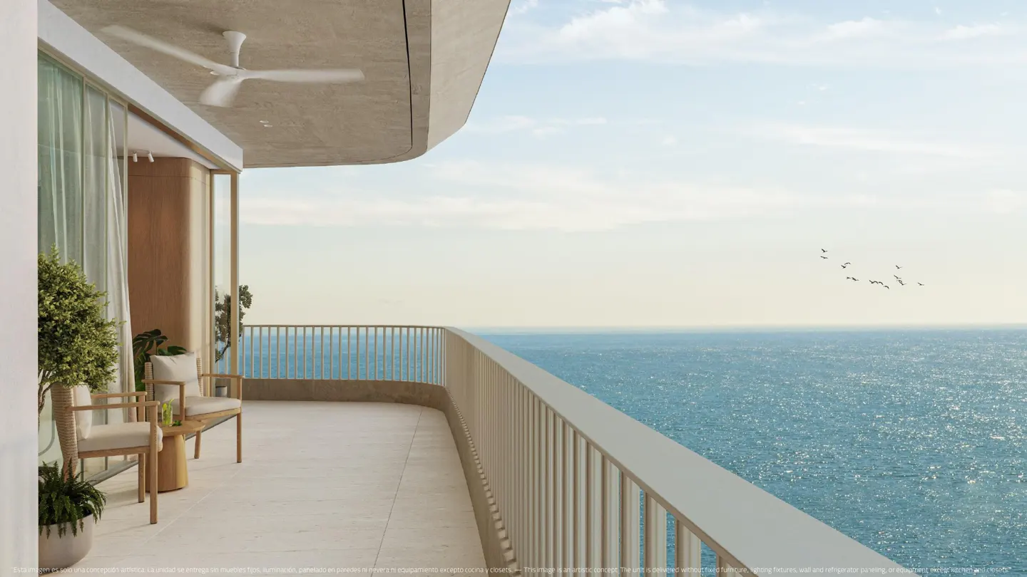 A curved balcony with two chairs overlooks a blue ocean under a pale sky with birds flying in the distance.