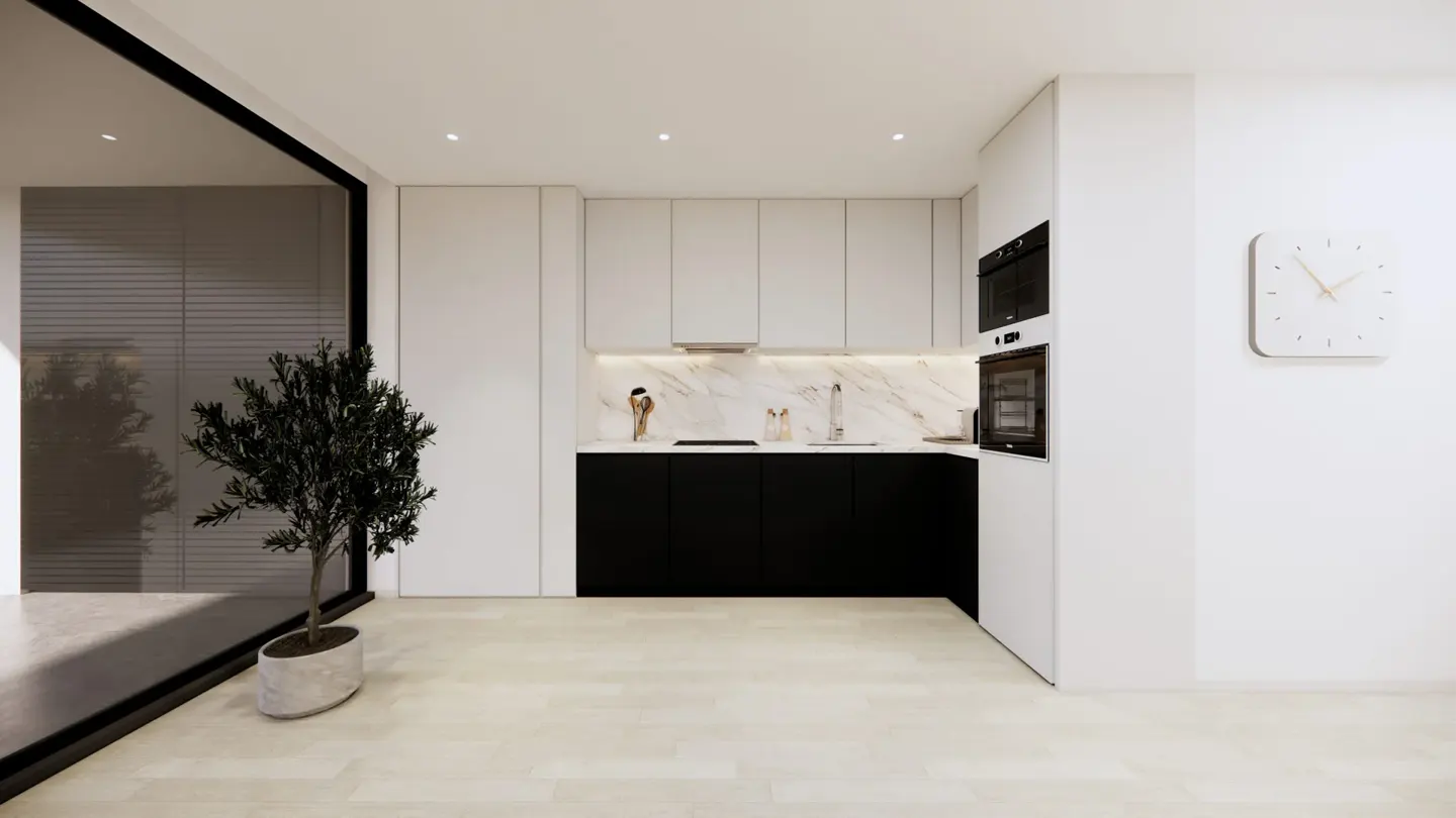 A modern kitchen with black lower cabinets, white upper cabinets, and a marble backsplash. A potted tree sits near a large window.