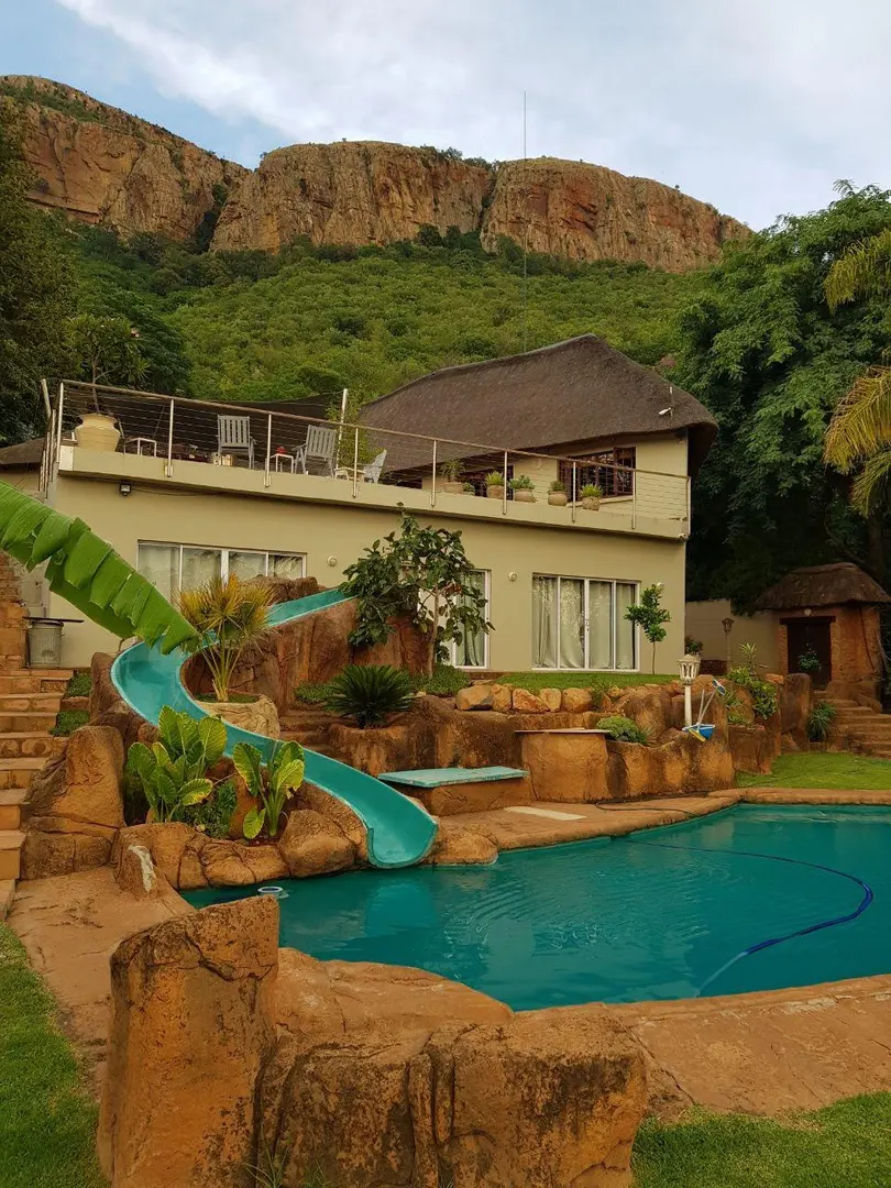 View of the house and swimming pool with slide