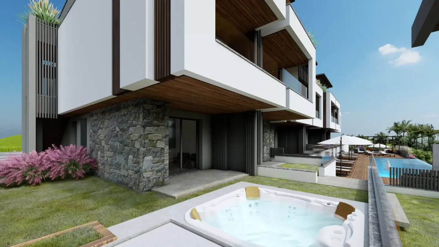 Modern white townhouses with stone accents, a hot tub, and a pool in the background.