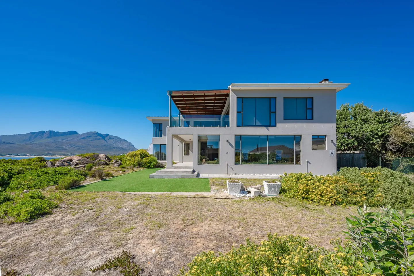 Large windows and stacker doors allow light to permeate this home