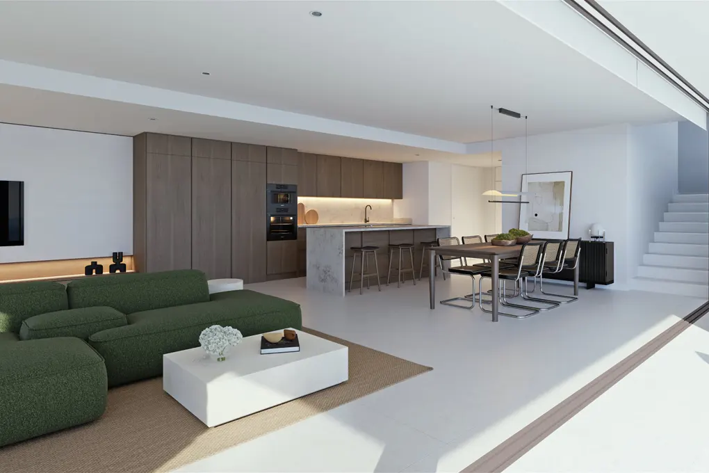Open-concept living space with a green sofa, white coffee table, kitchen island with stools, and a dining table with chairs.