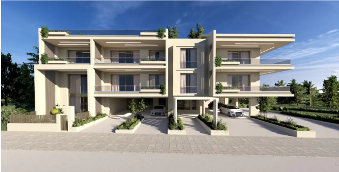 Three-story beige townhouses with glass balconies, greenery, and carports under a blue sky.