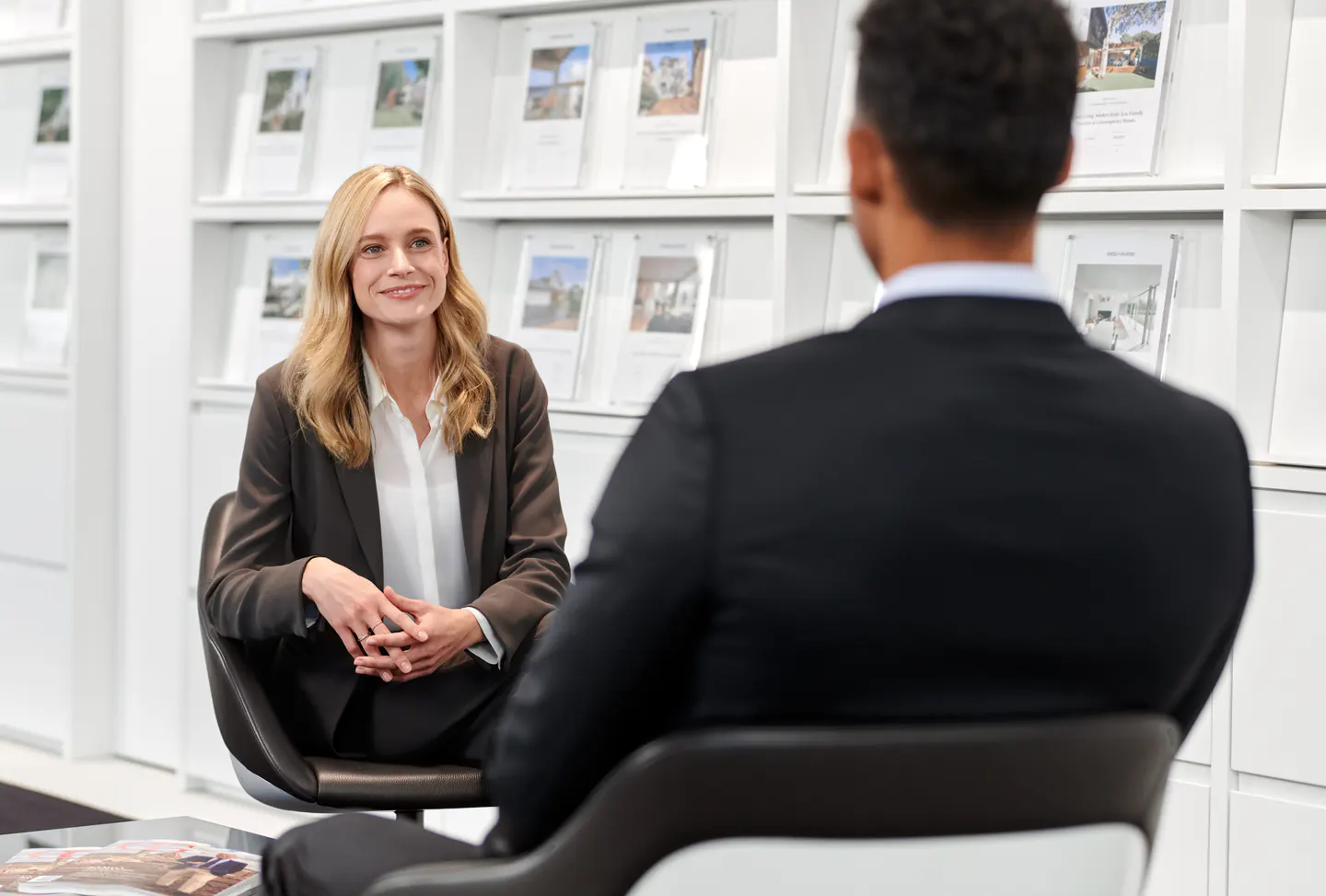 Real estate agent consulting with a client in an office