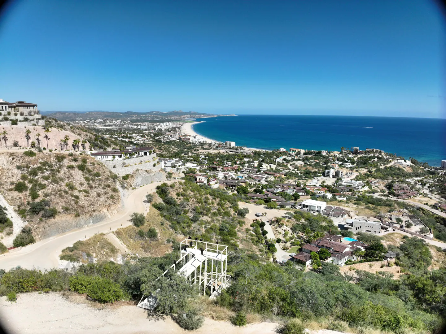 Ocean view of Cabo San Lucas, Mexico, with hillside homes and a white observation tower in the foreground.