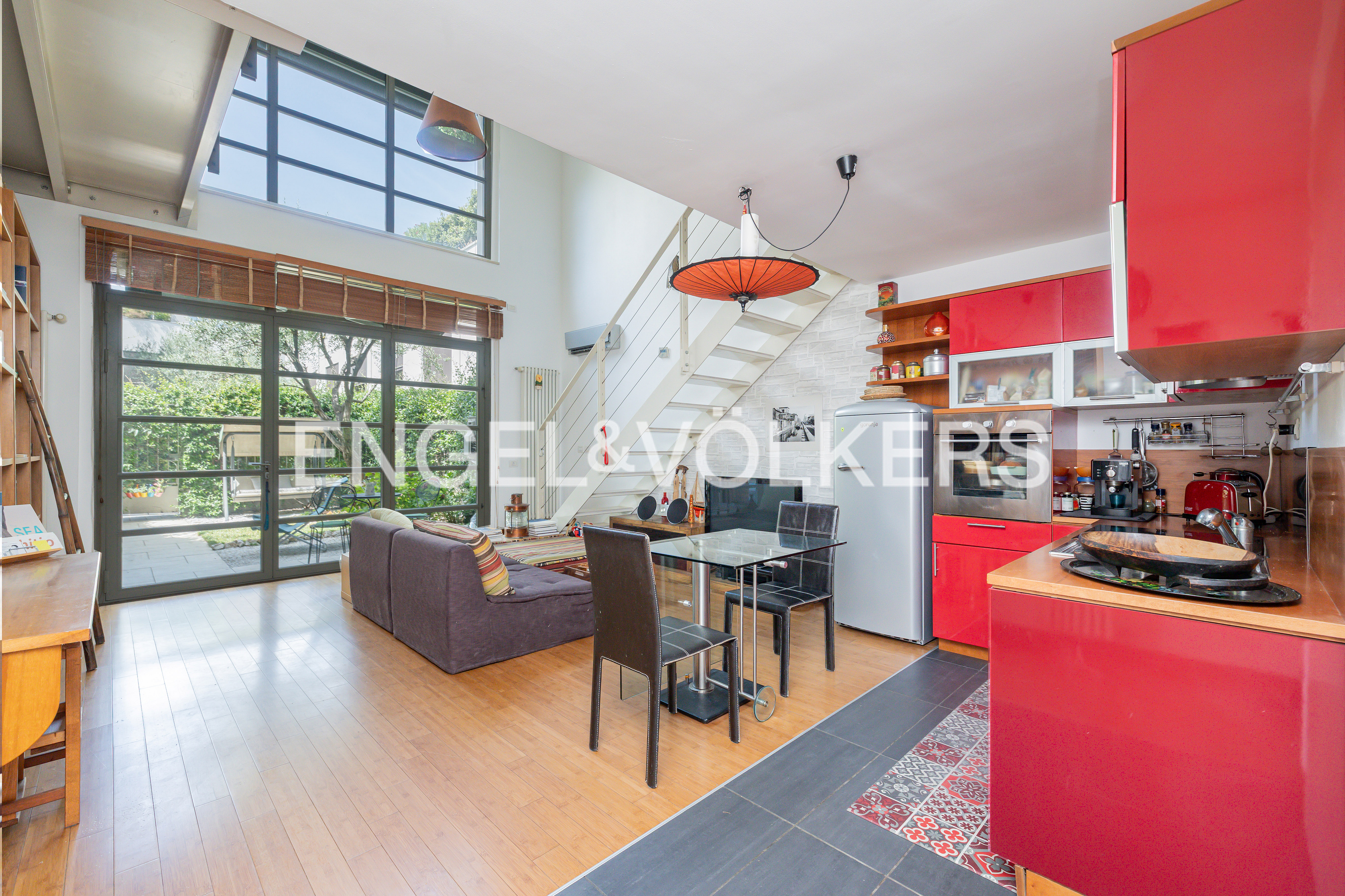 Contemporary loft with private patio and double-height ceiling in Nolo