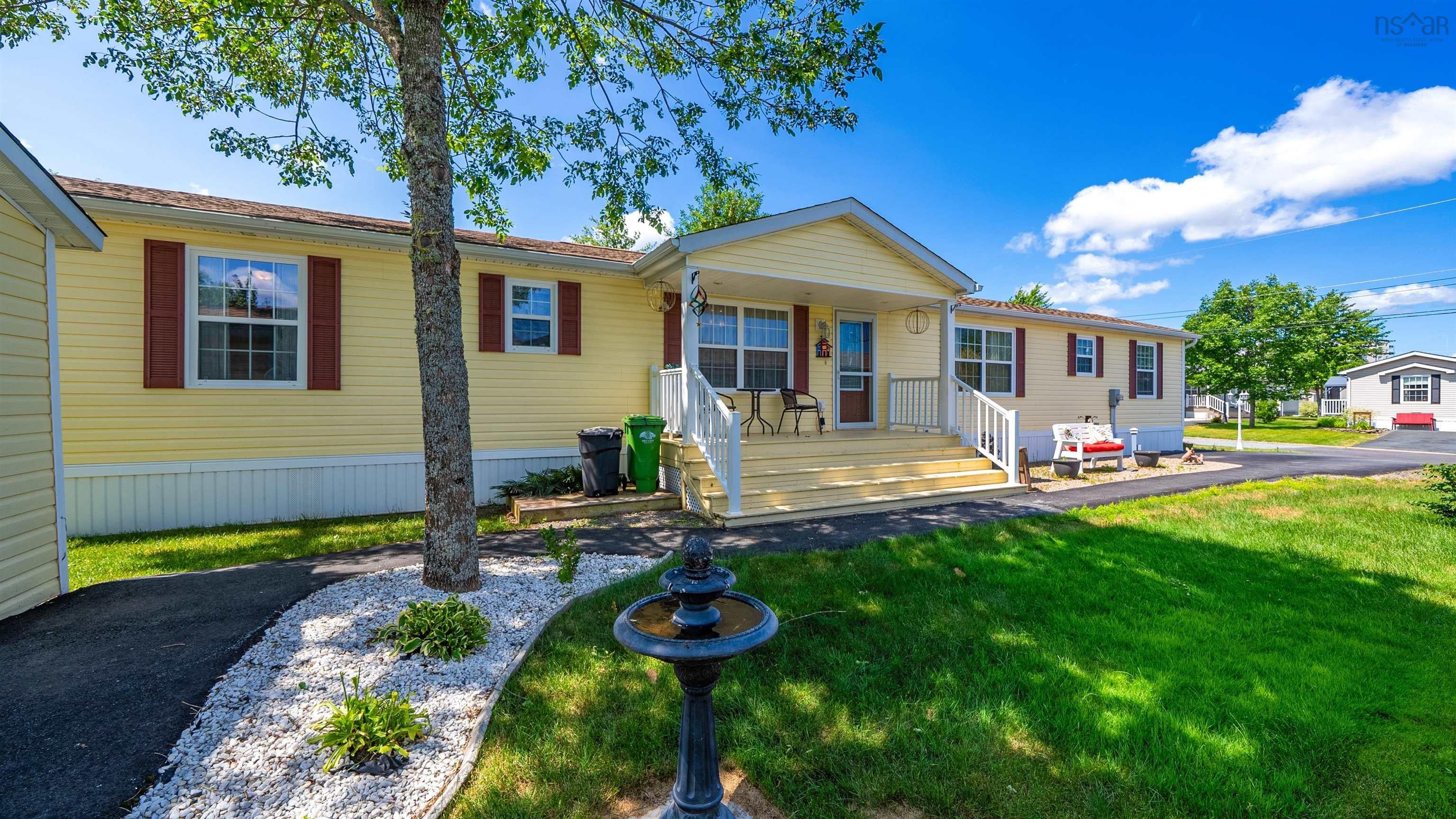 Serene 55+ Living: Mini Home with Sunroom & Forest Backdrop