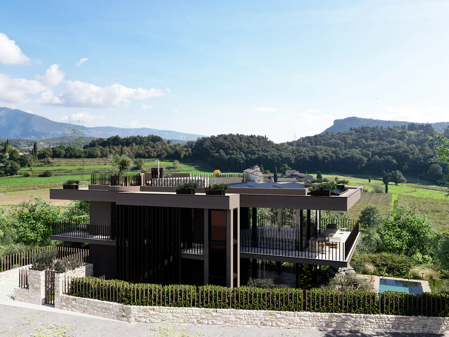 Modern two-story home with a flat roof, dark exterior, and balconies overlooking a pool and green fields.