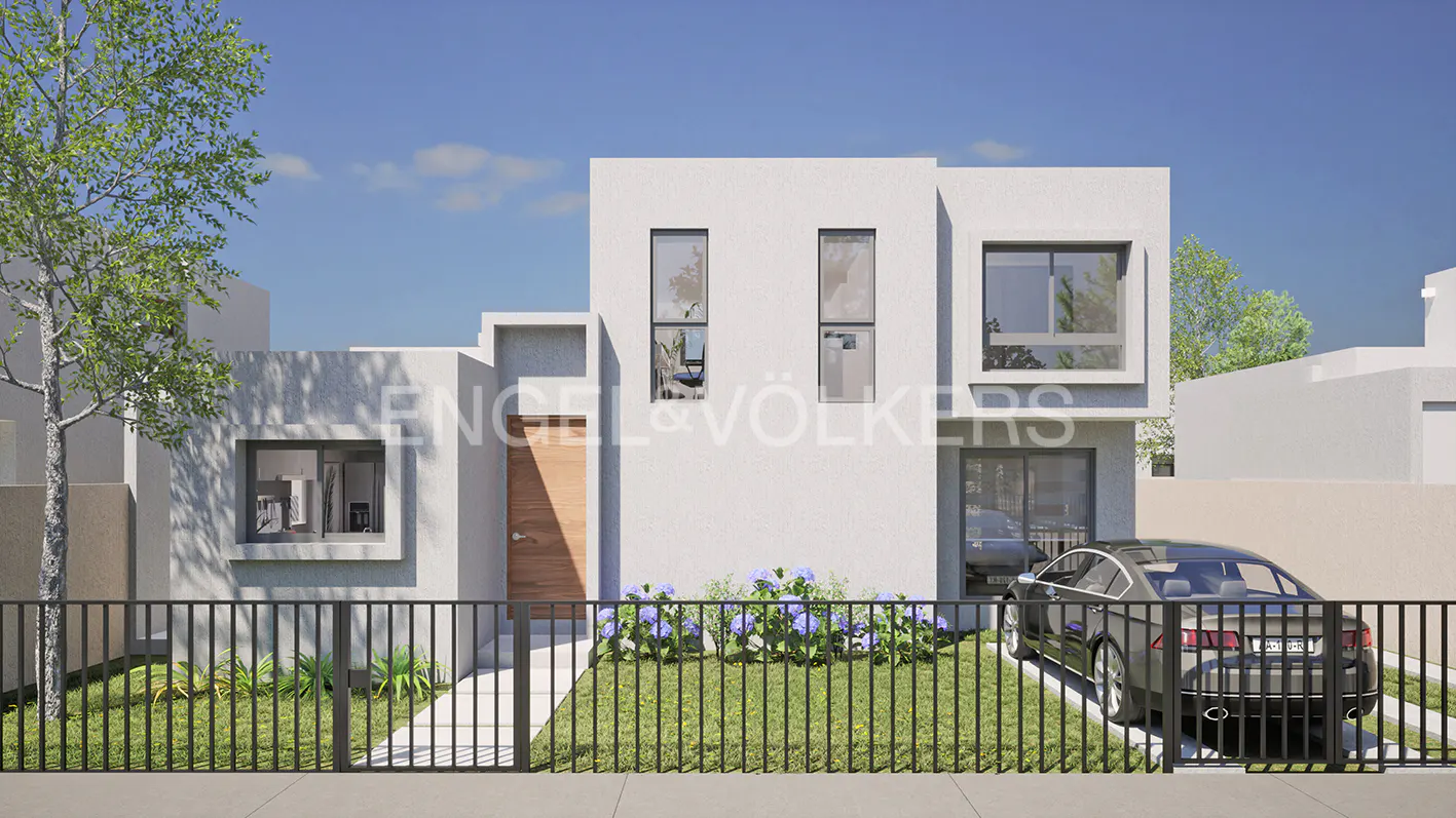 Modern two-story white house with a brown door, black fence, and a black car parked in the driveway. Engel & Völkers logo visible.
