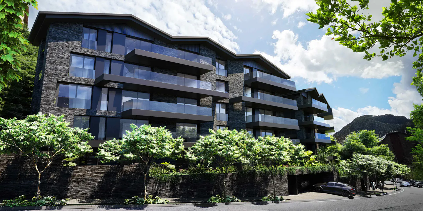 Modern dark stone apartment building with glass balconies, surrounded by green trees and a mountain backdrop under a cloudy sky.