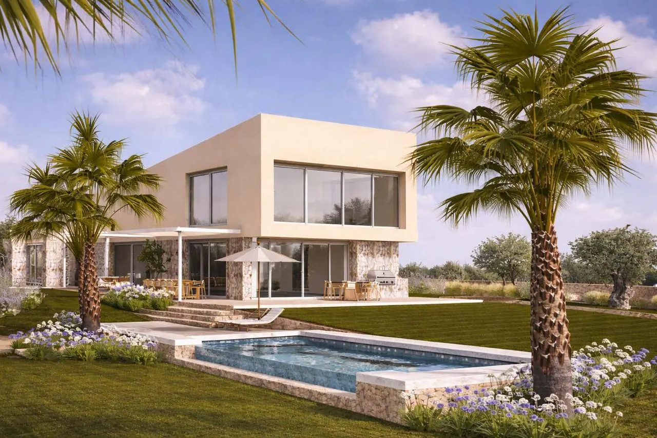 Modern two-story beige villa with a pool, palm trees, and landscaped garden under a bright blue sky.
