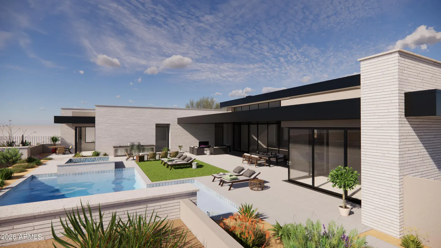 Modern home exterior with a pool, patio furniture, and desert landscaping under a blue sky.