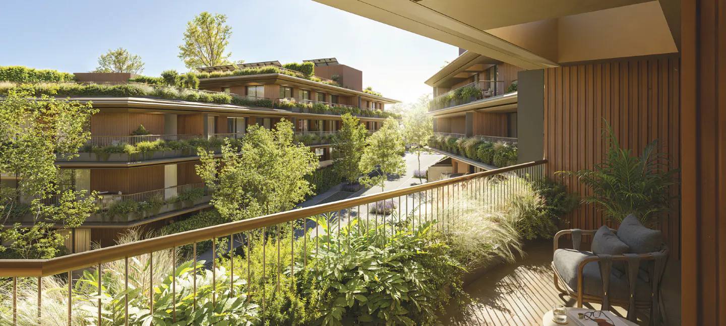 View from a balcony with a chair and plants, overlooking buildings with green roofs and trees.