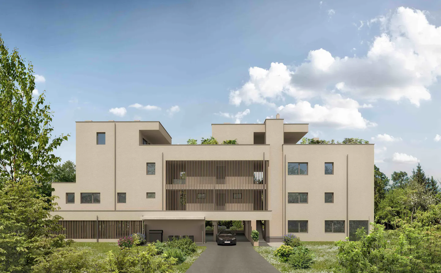 Modern beige apartment building with a car parked underneath, surrounded by green trees and a blue sky.