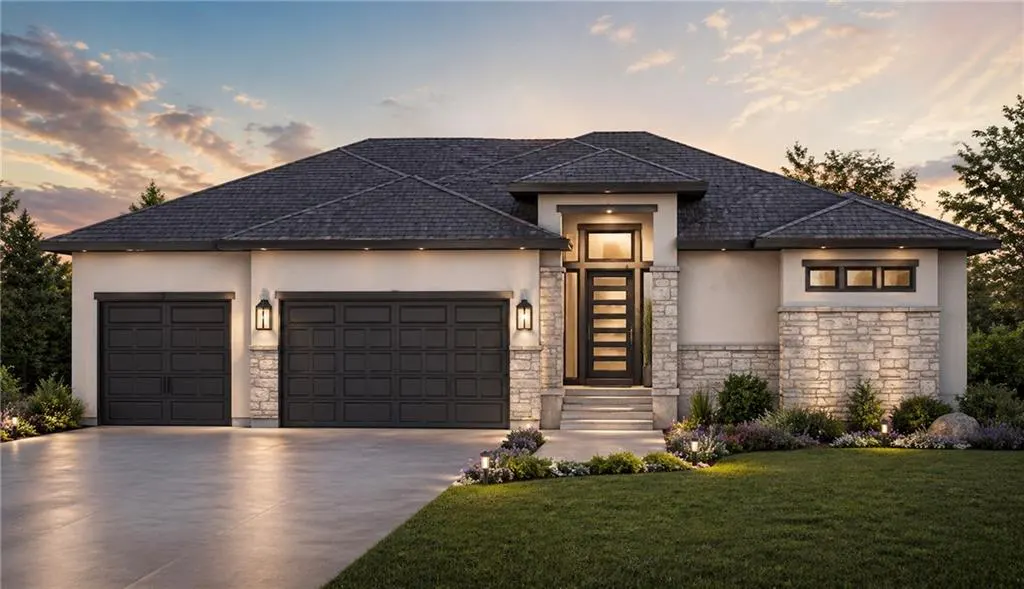 A modern, single-story home with a gray roof, beige stucco, stone accents, and a dark garage door. A green lawn and colorful flowers are in front.