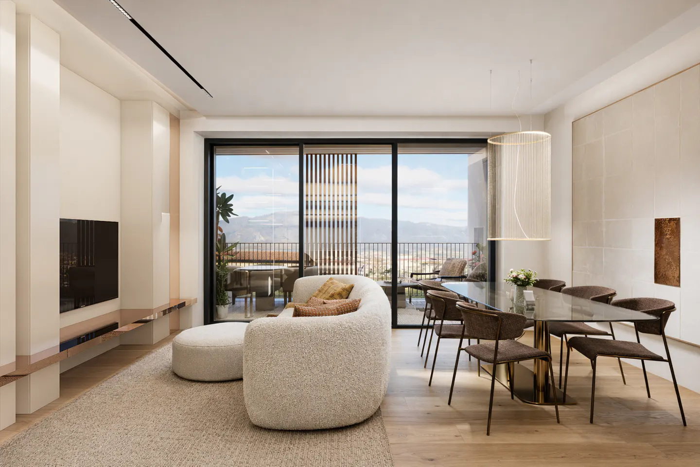 Bright, modern living room with a white sofa, glass table, and mountain view from the balcony.