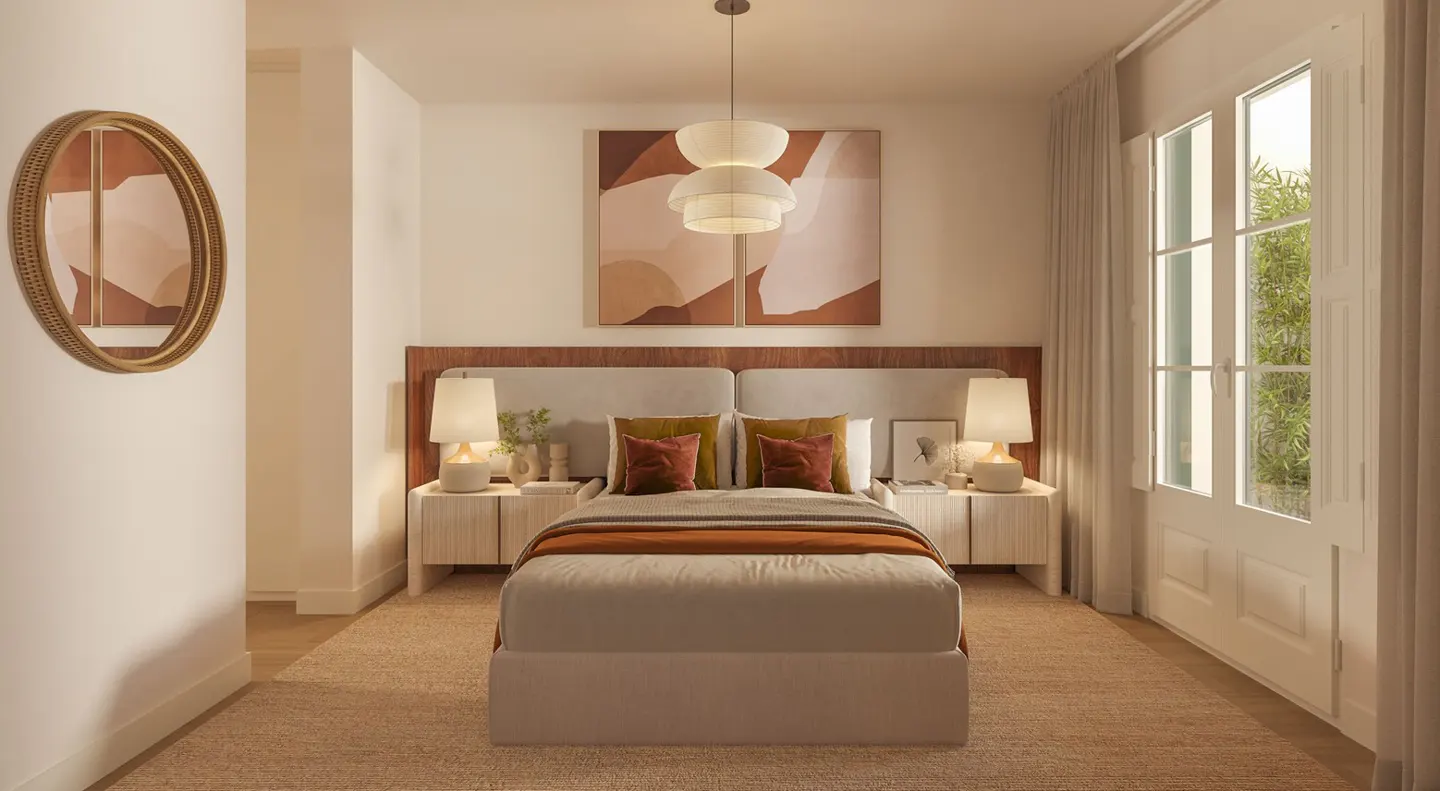 A bedroom with a bed, two nightstands, and a window. The walls are white, and the floor is carpeted. There is a mirror on the wall.