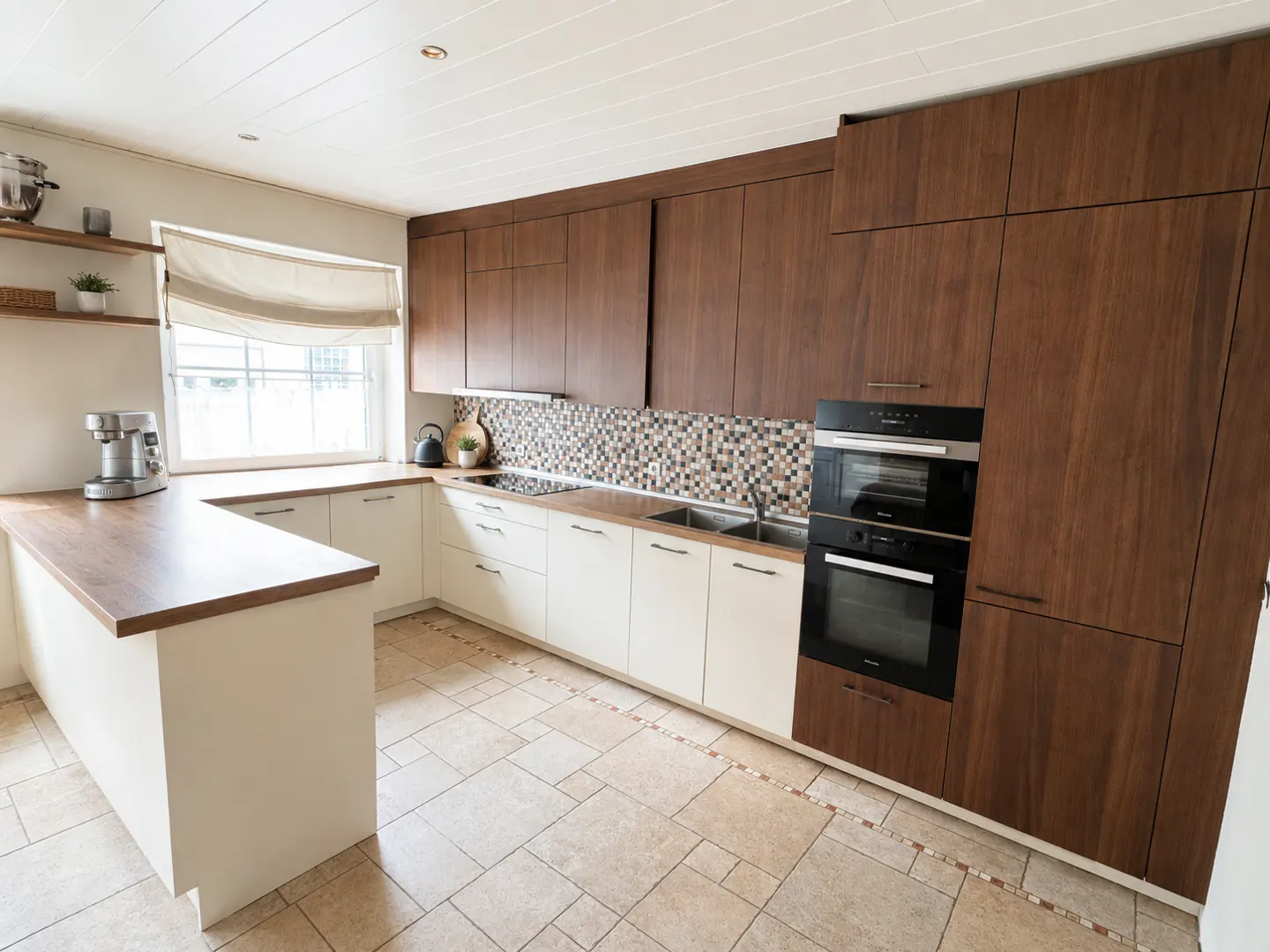A modern kitchen with white lower cabinets, brown upper cabinets, and a mosaic backsplash. A black oven is built into the cabinets.