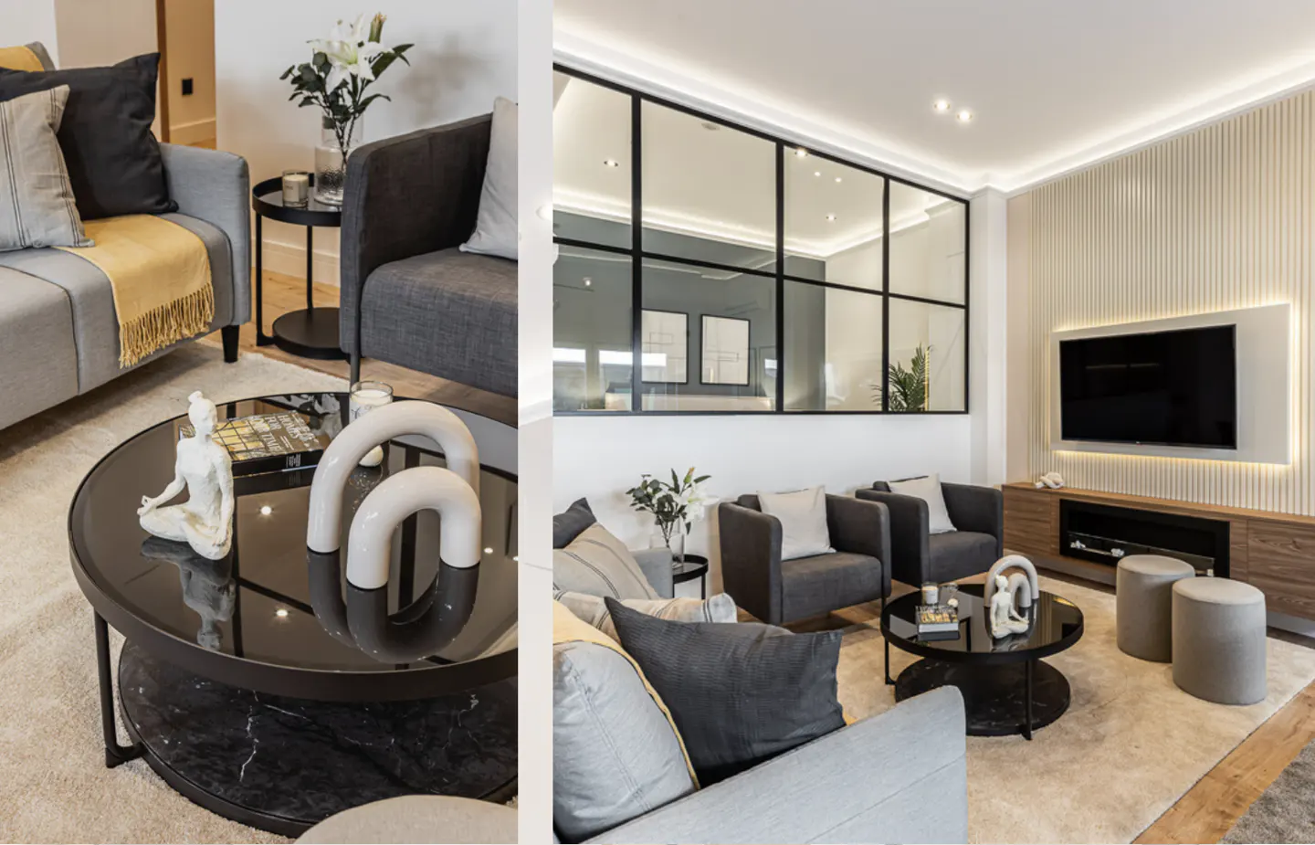A modern living room with gray sofas, a black coffee table with a yoga statue, and a large window wall.