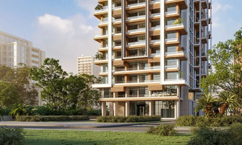 Modern high-rise apartment building with balconies, white and wood accents, surrounded by green grass and trees.