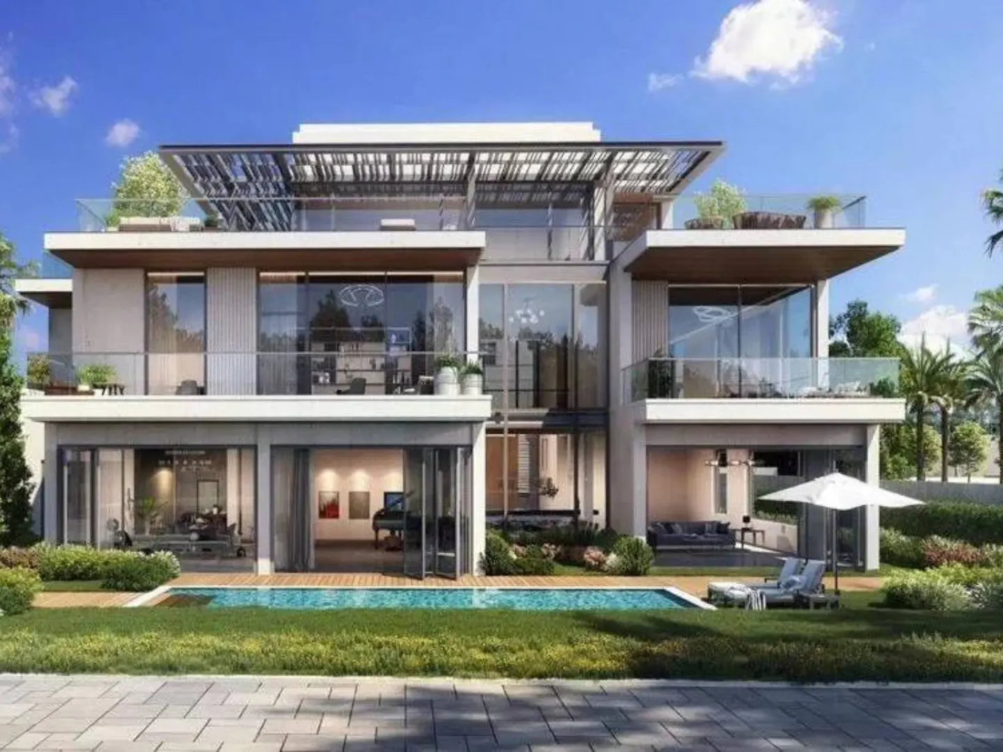 Modern three-story home with a pool and patio. The house is white with large windows and balconies. A white umbrella shades lounge chairs.