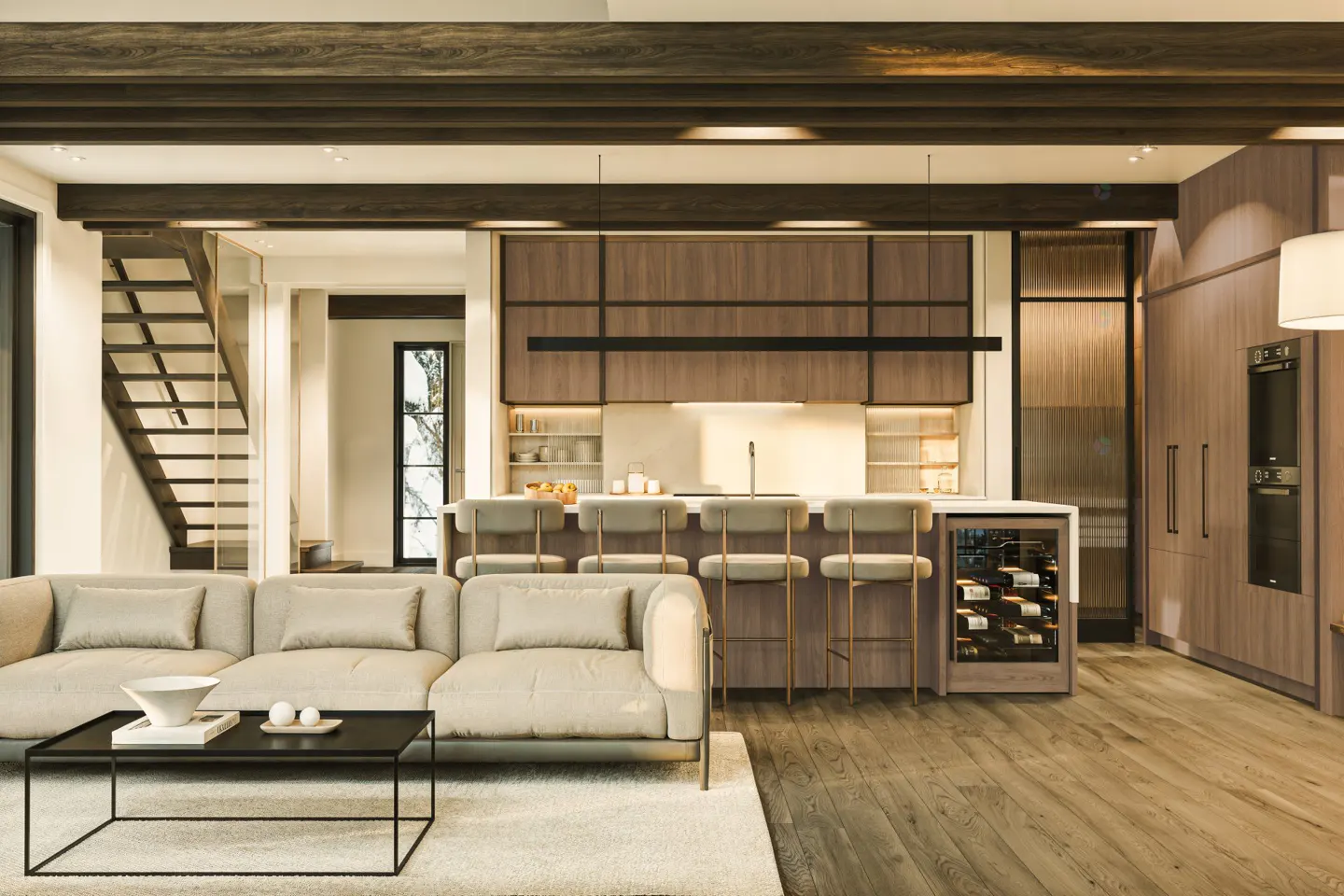 Open-concept living space with a beige sofa, black coffee table, and kitchen island with bar stools. Wood floors and cabinets add warmth.