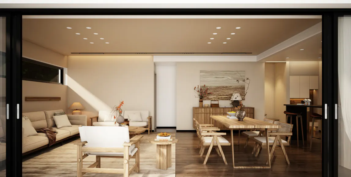 A bright, modern living and dining area with light wood furniture and neutral tones, viewed through sliding glass doors.