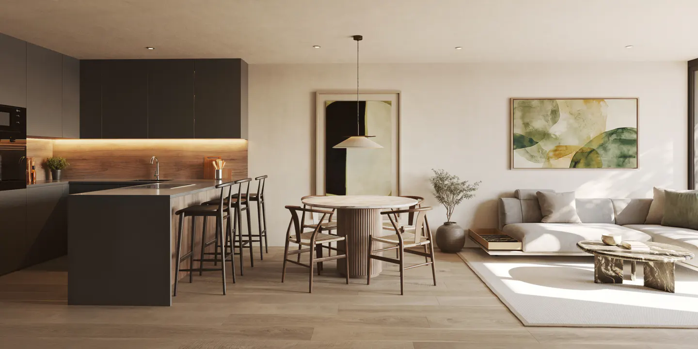 Open-concept living space with a gray kitchen island, round dining table, and a gray sofa under abstract art.