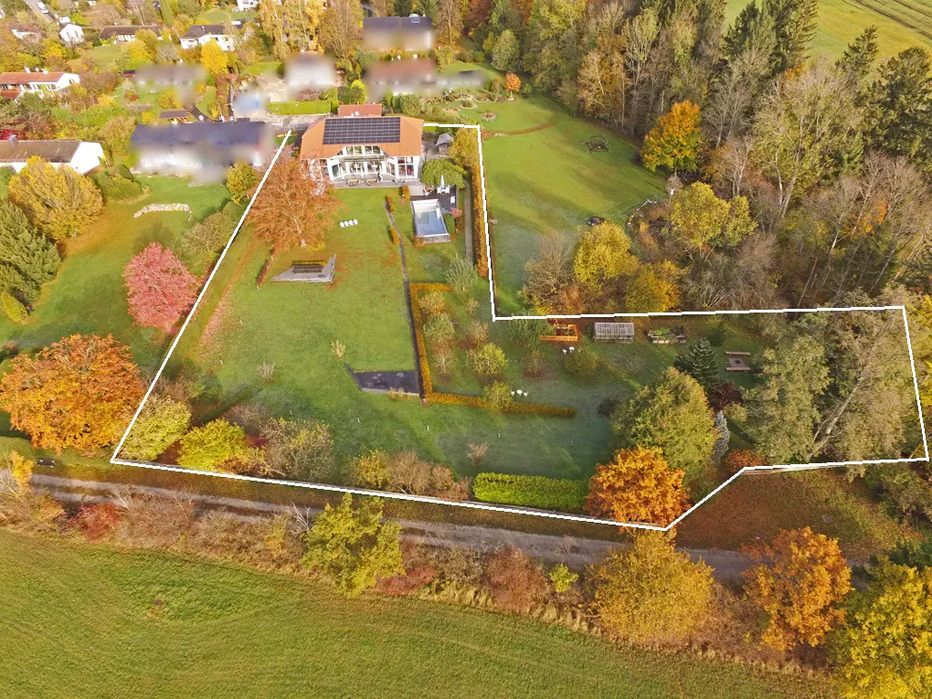 Aerial view of a property with a house, pool, garden, and surrounding trees in autumn colors, outlined in white.